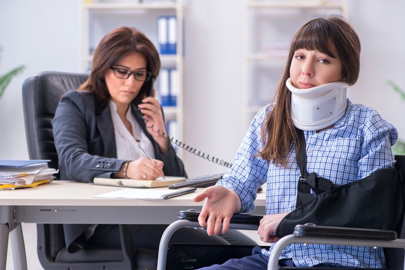 Injured employee visiting lawyer for advice on insurance